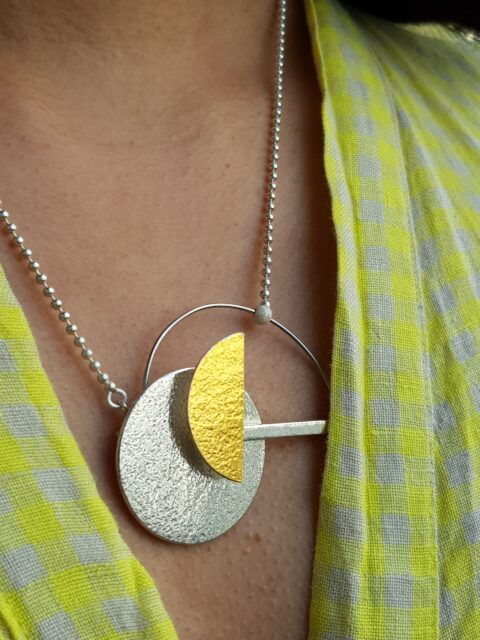 A geometric pendant made in silver, gold leaf and steel 