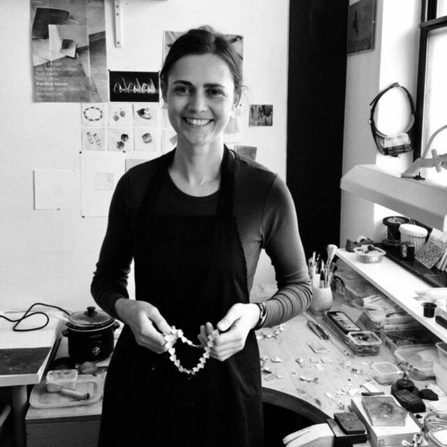 Black and white photograph of Karolina Baines in her jewellery studio